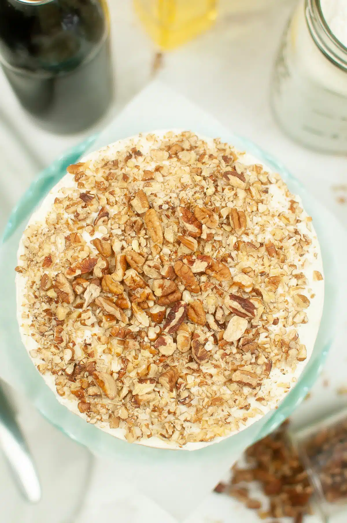 overhead of a carrot cake with chopped walnuts on top