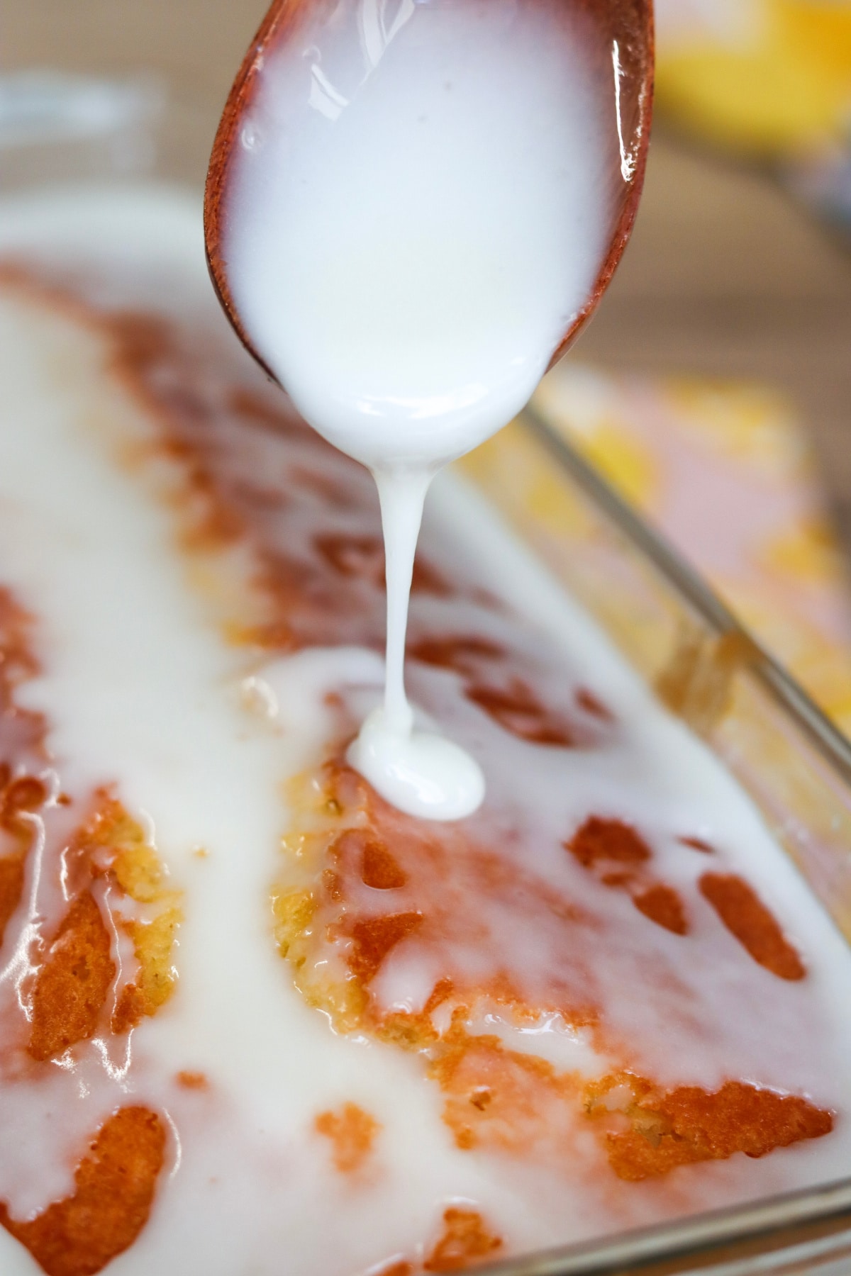 drizzling glaze over the top of the cake