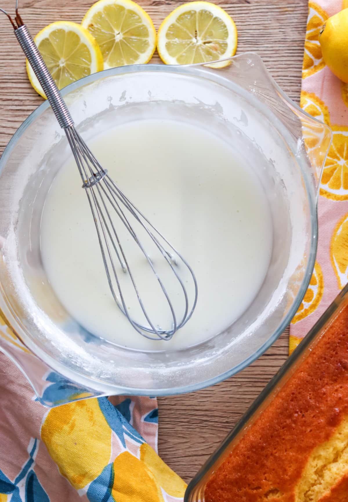 bowl og lemon glaze with whisk