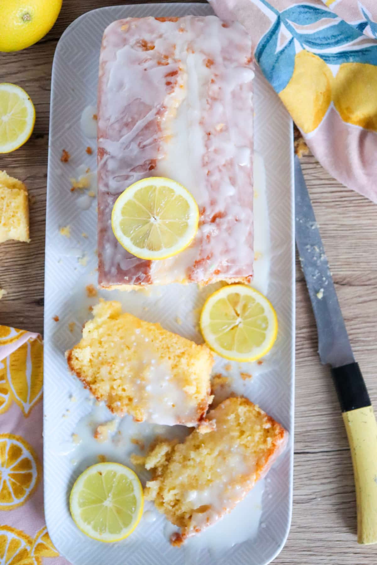overhead of a lemon loaf cake with fresh lemon slices on top