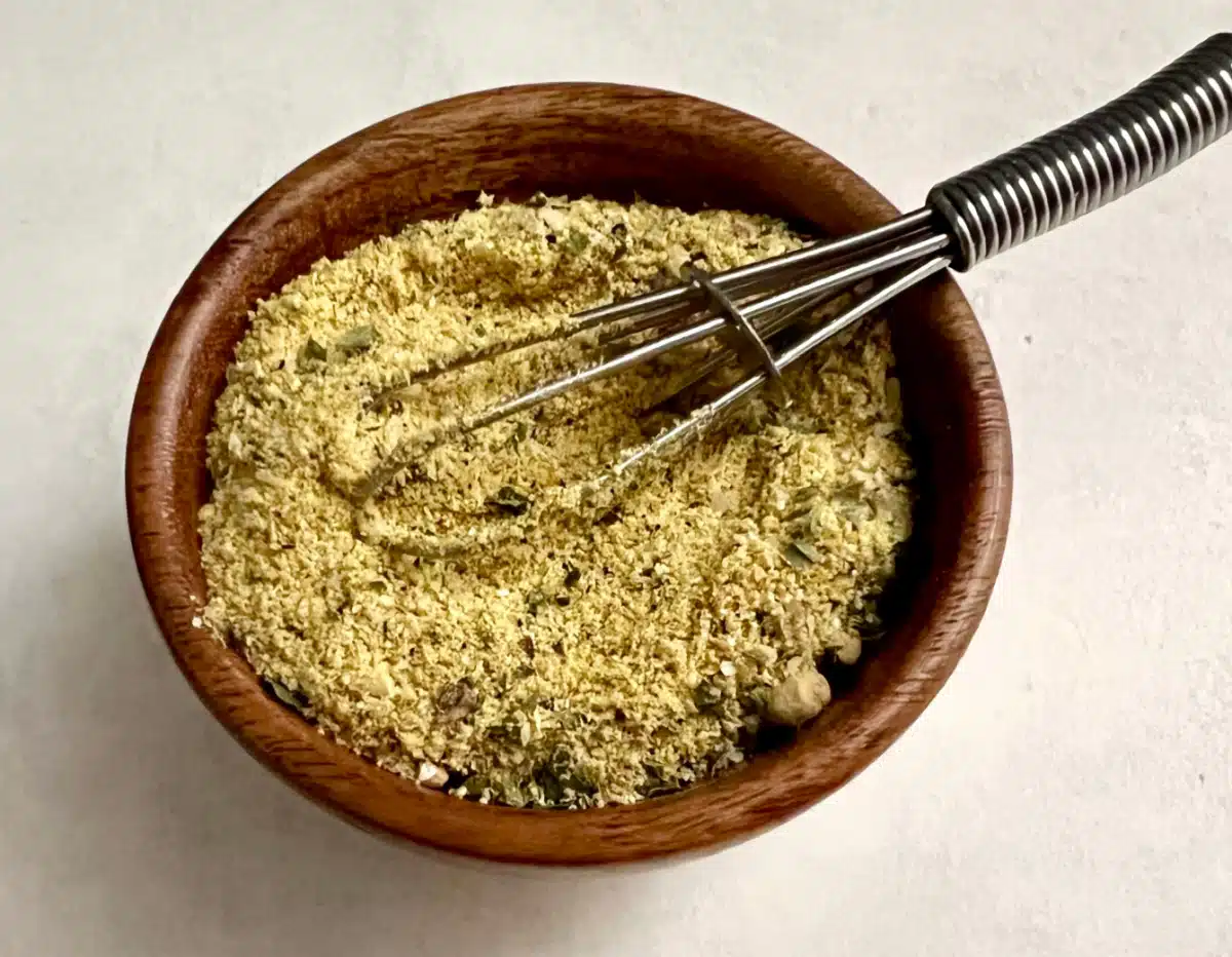 mixing ramen seasoning packe ingredients in a wooden bowl