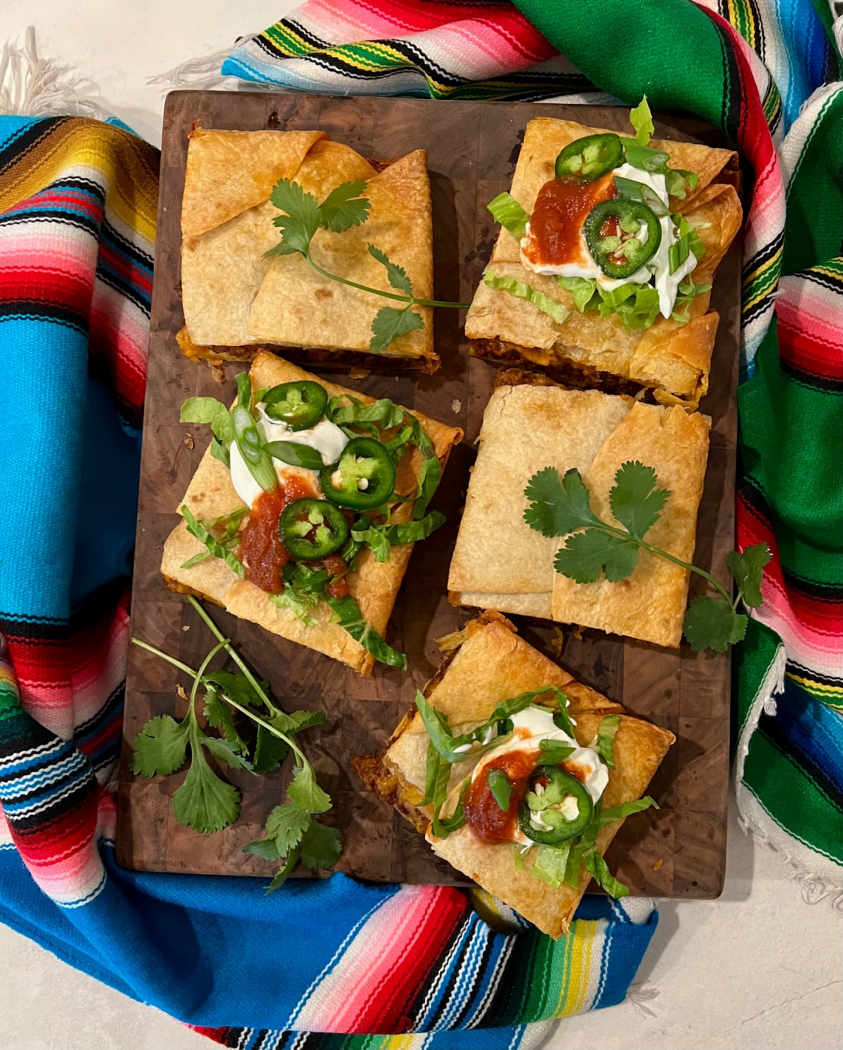 overhead of sheet pan tacos on a wooden board