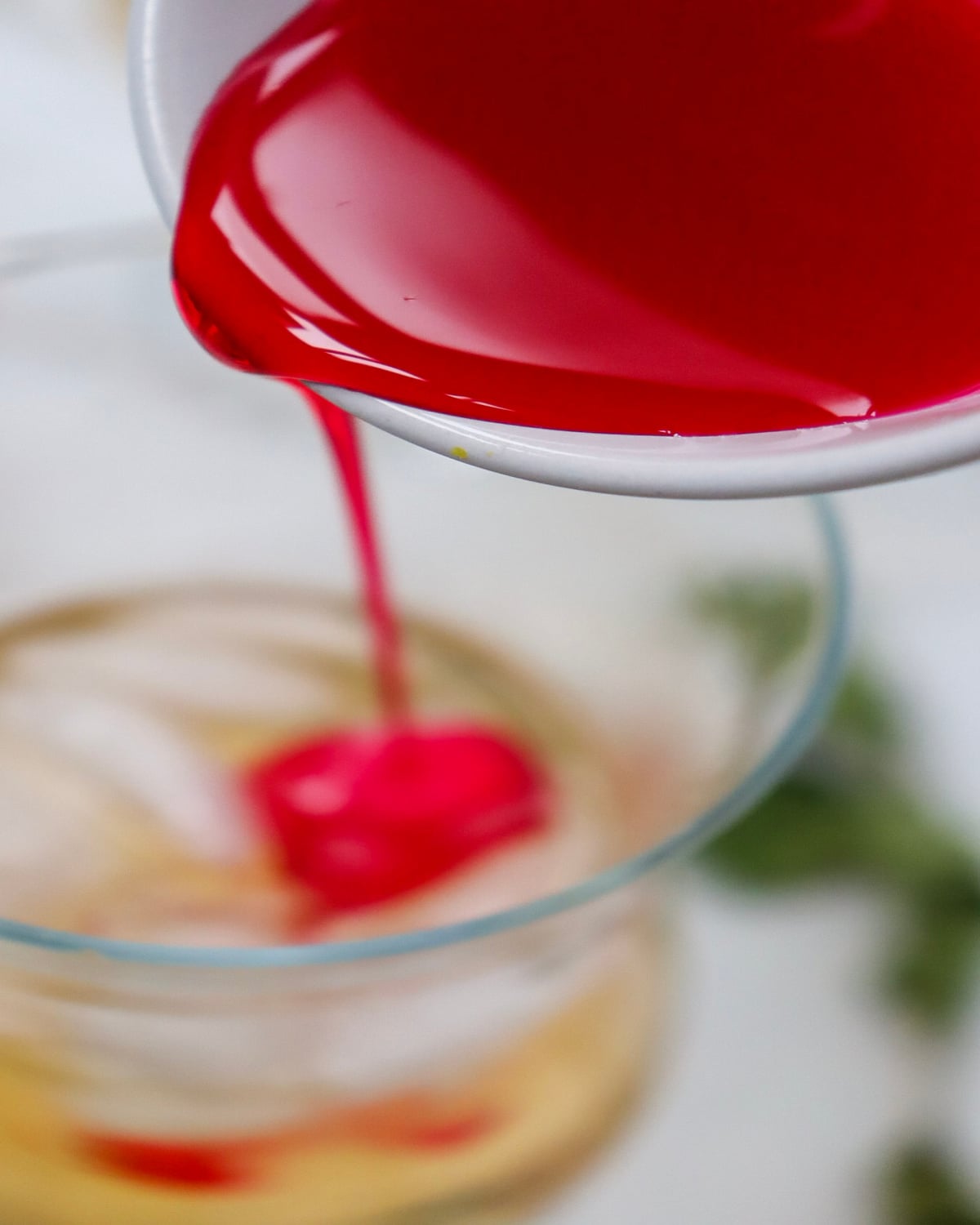 adding grenadine to a glass of soda