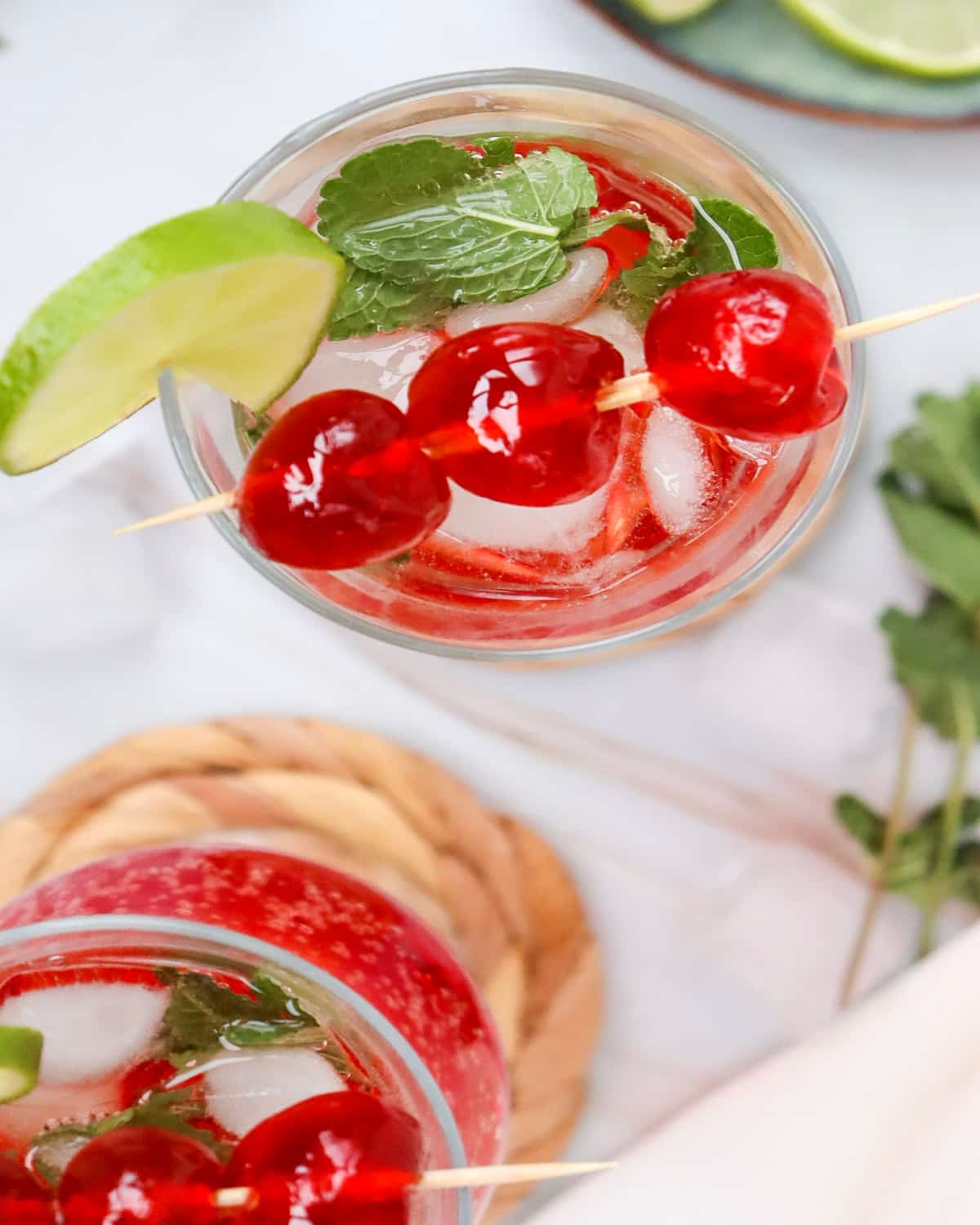 garnishing drinks with marachino cherries, lime and mint