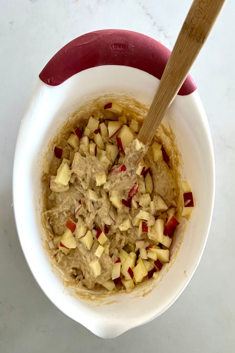 adding apple pieces to the batter
