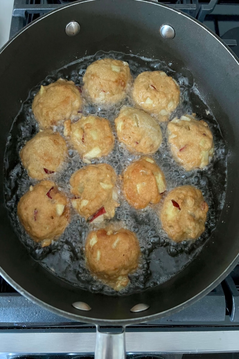 frying fritters in oil in a skillet