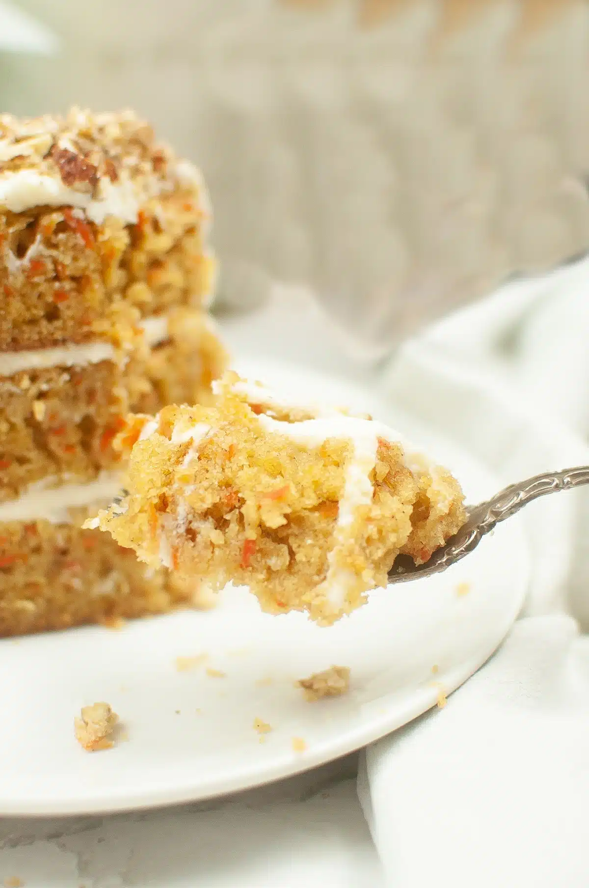 slice of carrot cake with carrot cake on a fork
