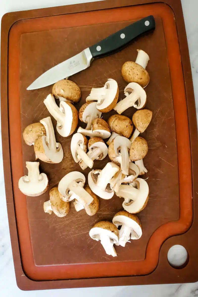 slicing mushrooms on a cutting board