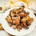air fryer mushrooms on a white plate with a yellow napkin