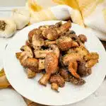 air fryer mushrooms on a white plate with a yellow napkin