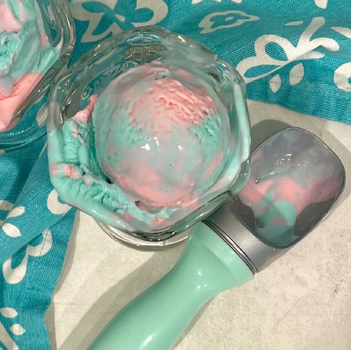 overhead of cotton candy ice cream with a scooper