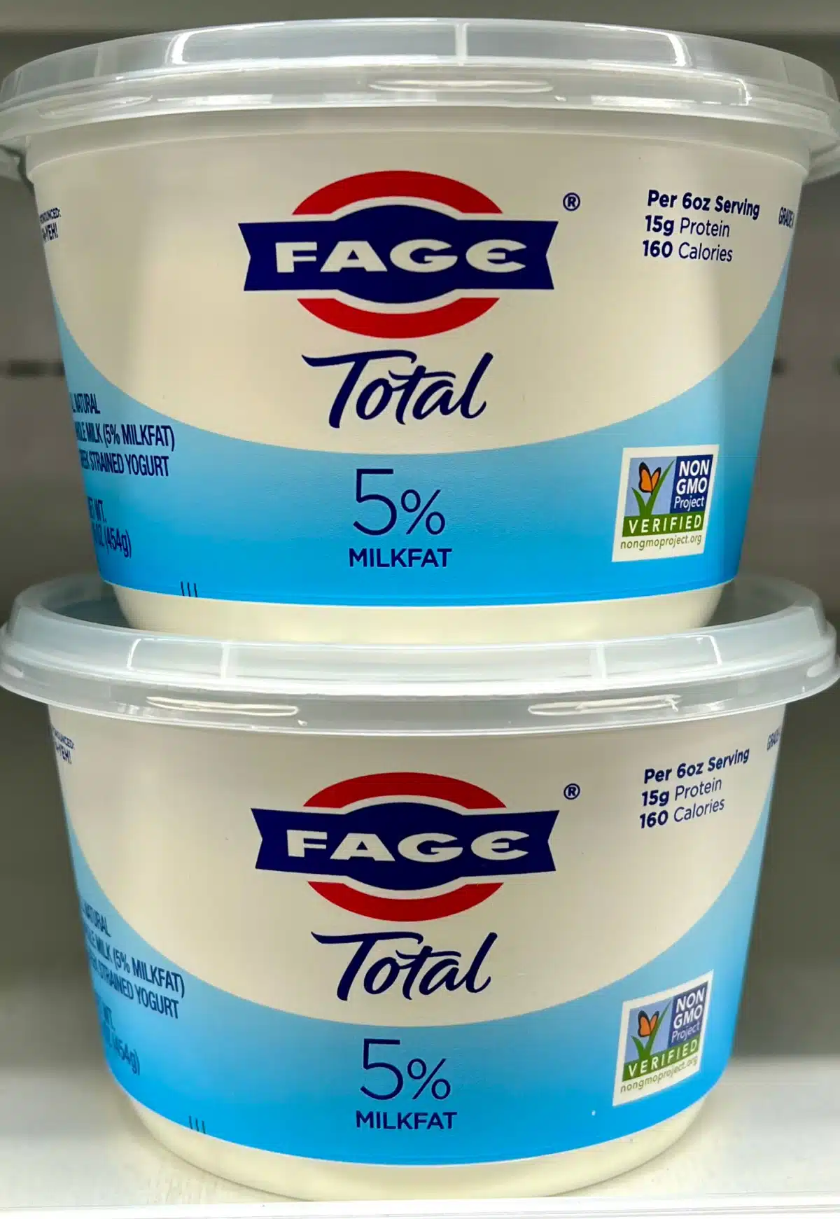 two containers of Greek yogurt stacked