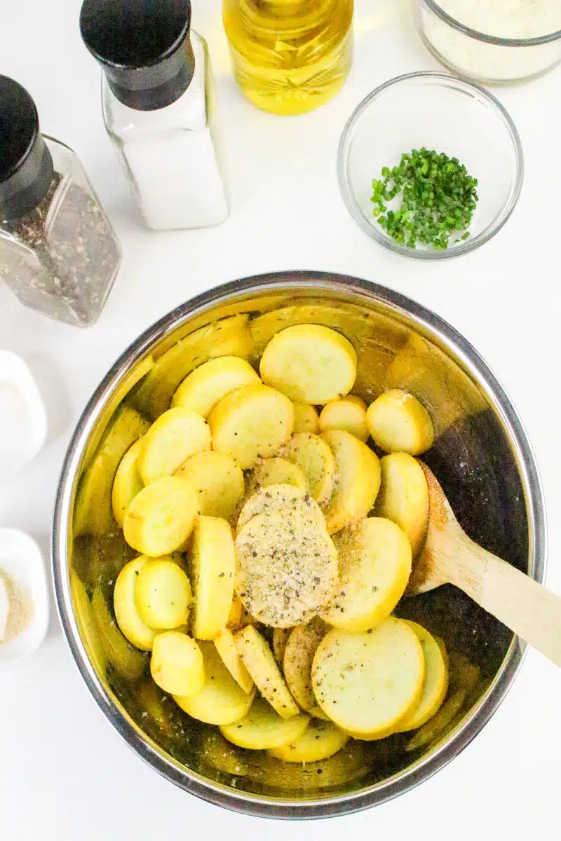 mixing summer squash with seasonings in a bowl