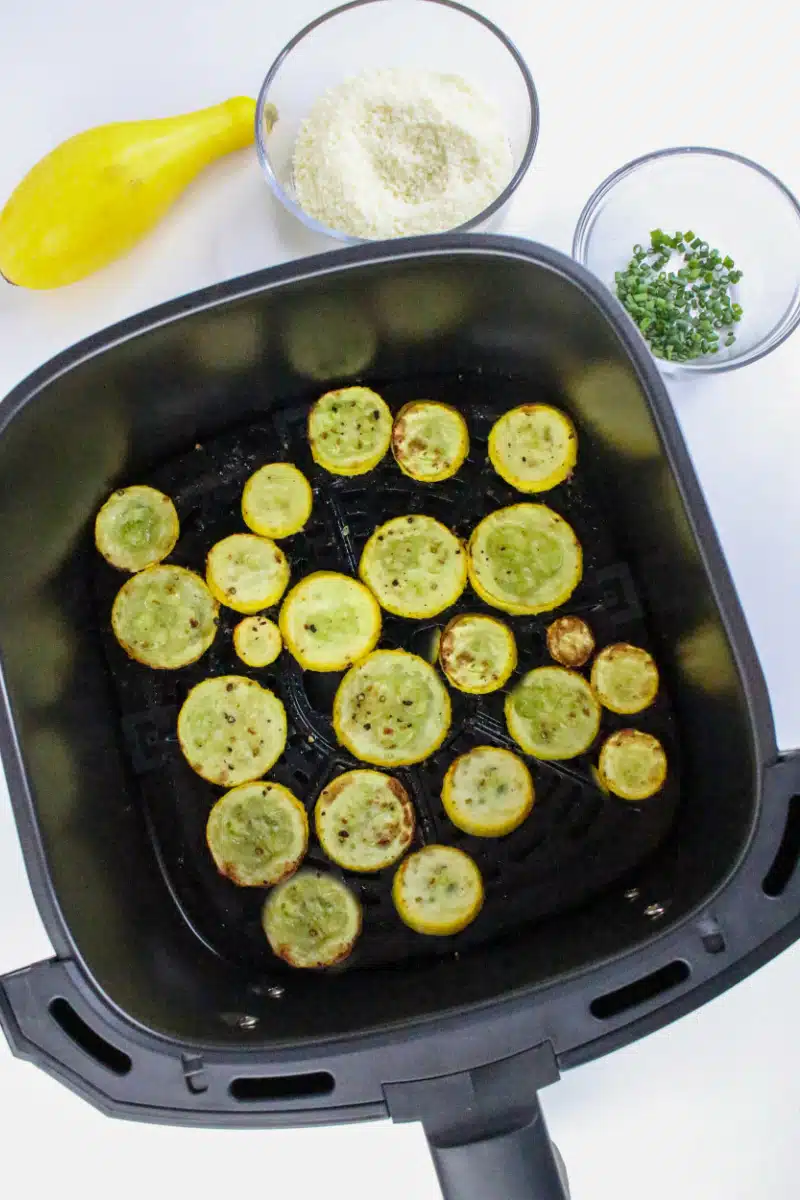 cooked summer squash in an air fryer basket