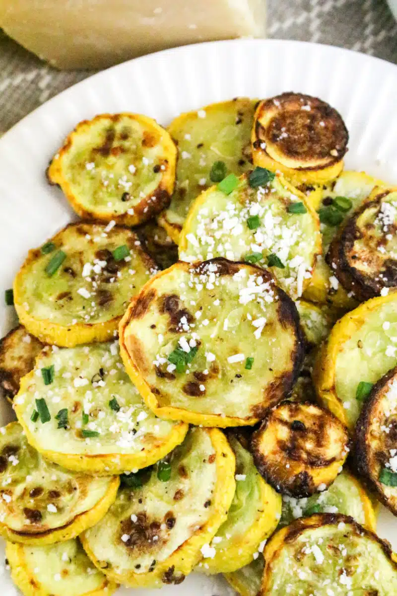 cooked yellow squash with Parmesan cheese and chopped parsley