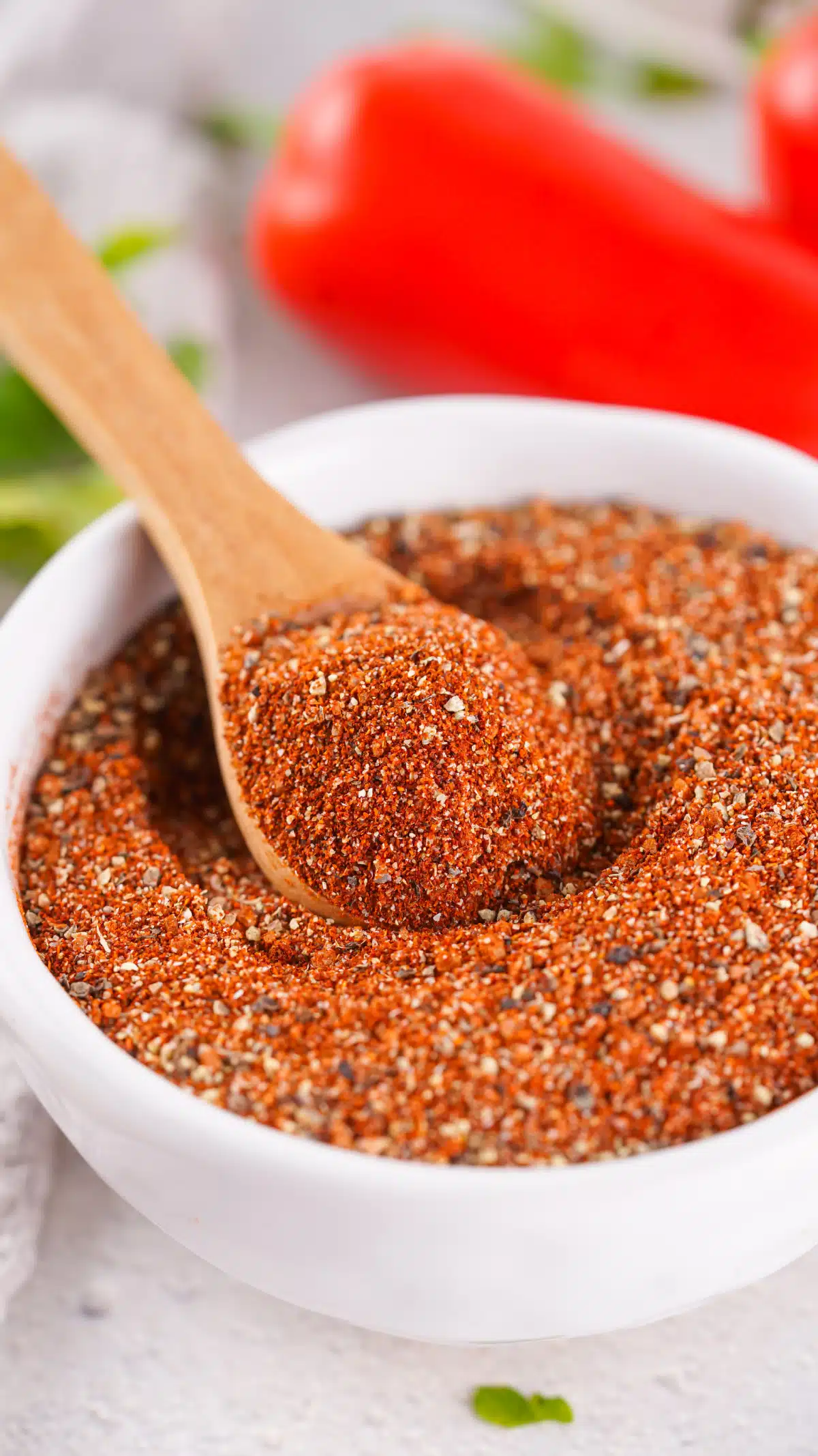 close up of barbecue seasoning in a bowl with a spoon