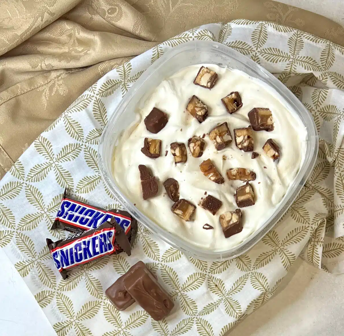 overhead of snickers ice cream in freezer-safe container