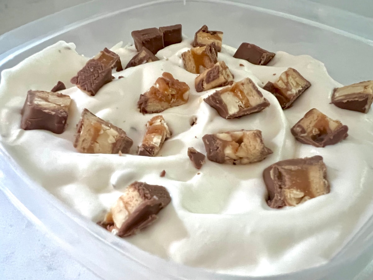 Snickers candy on top of ice cream