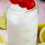 garnishing pina colada mocktail with cherries