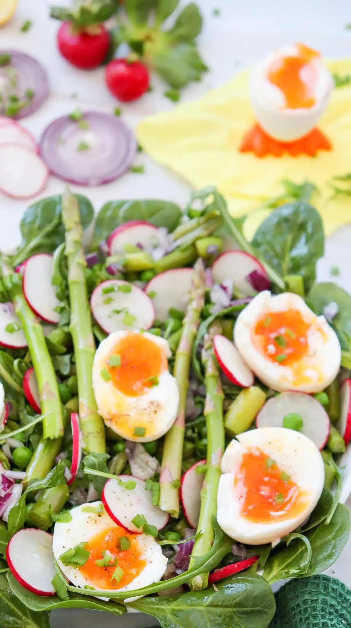 overhead of spinach salad with eggs