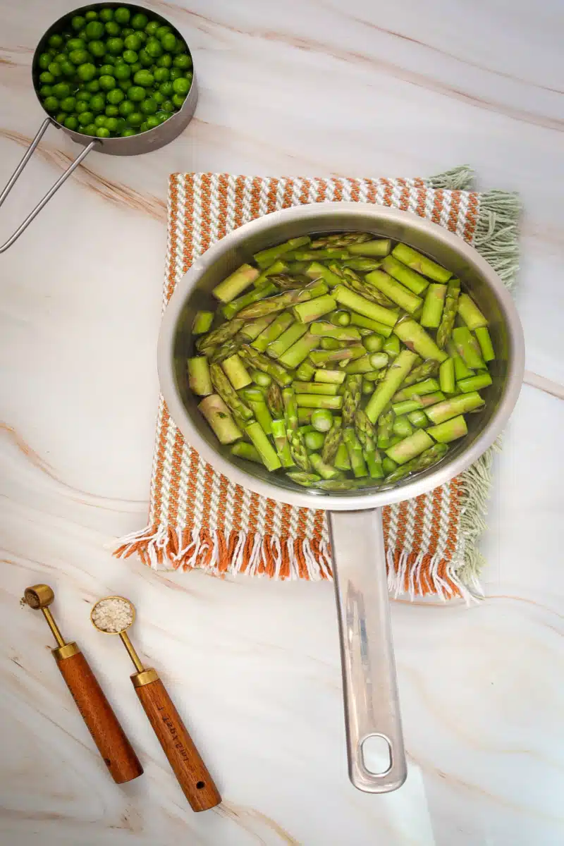 blanching asparagus and peas in a pot