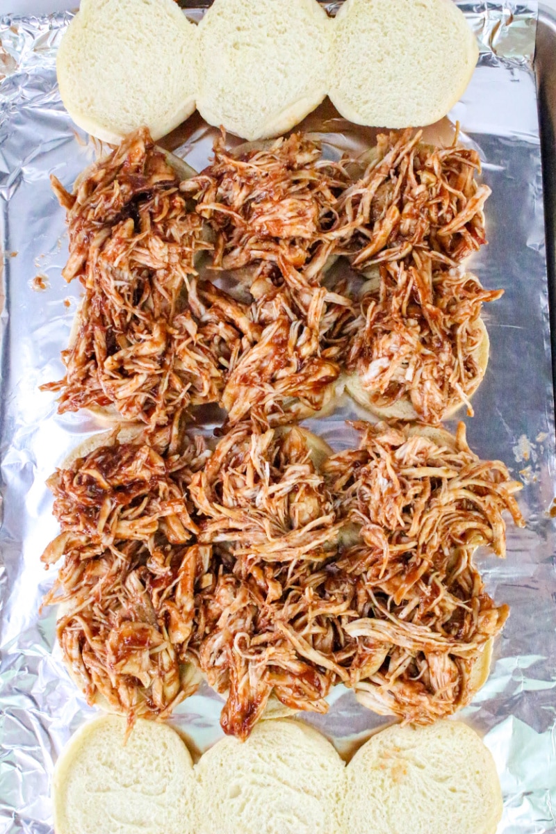 spreading chicken mixture over rolls