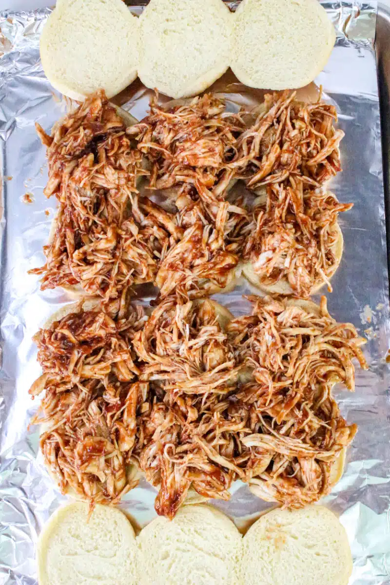 spreading chicken mixture over rolls