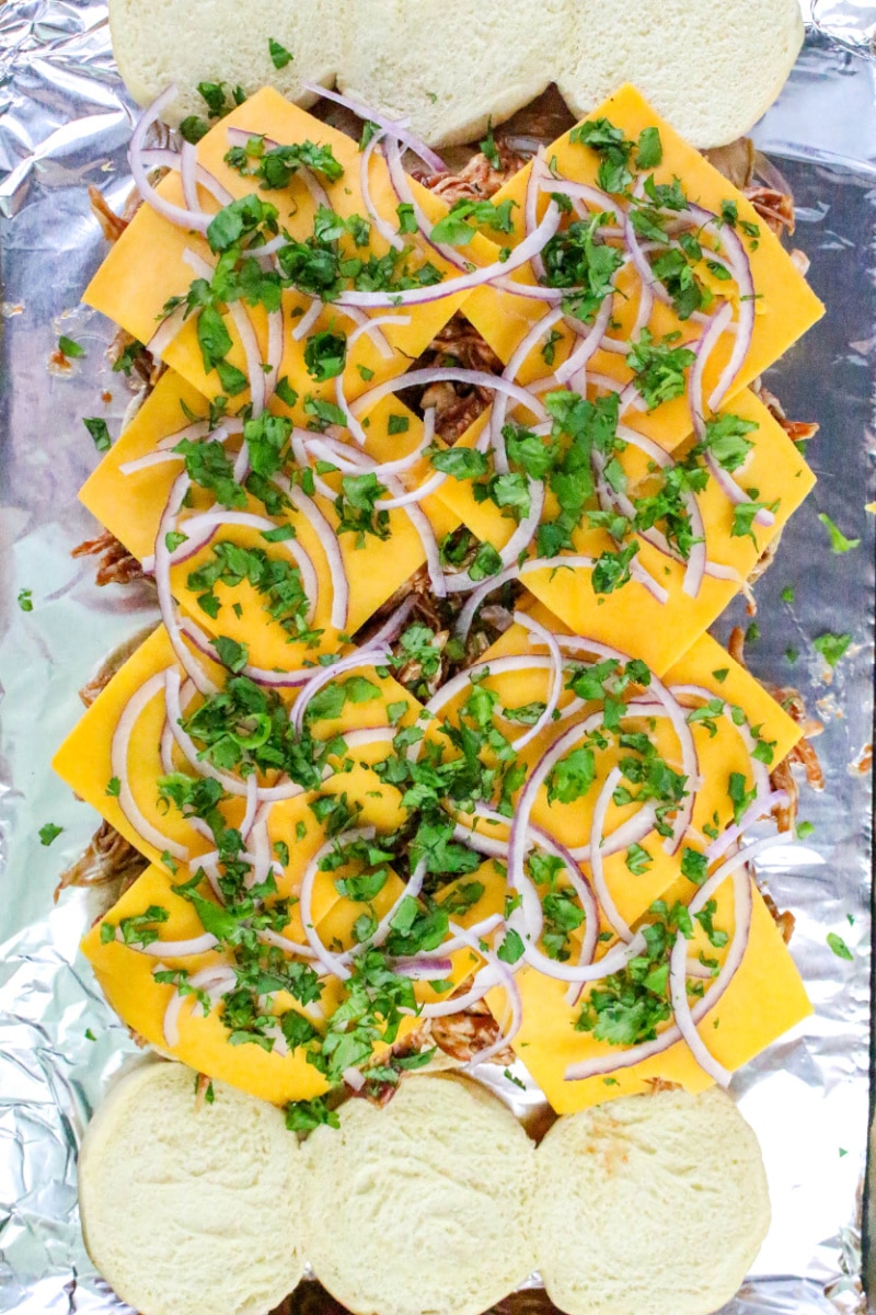 topping slider filling with cheese, red onion and cilantro