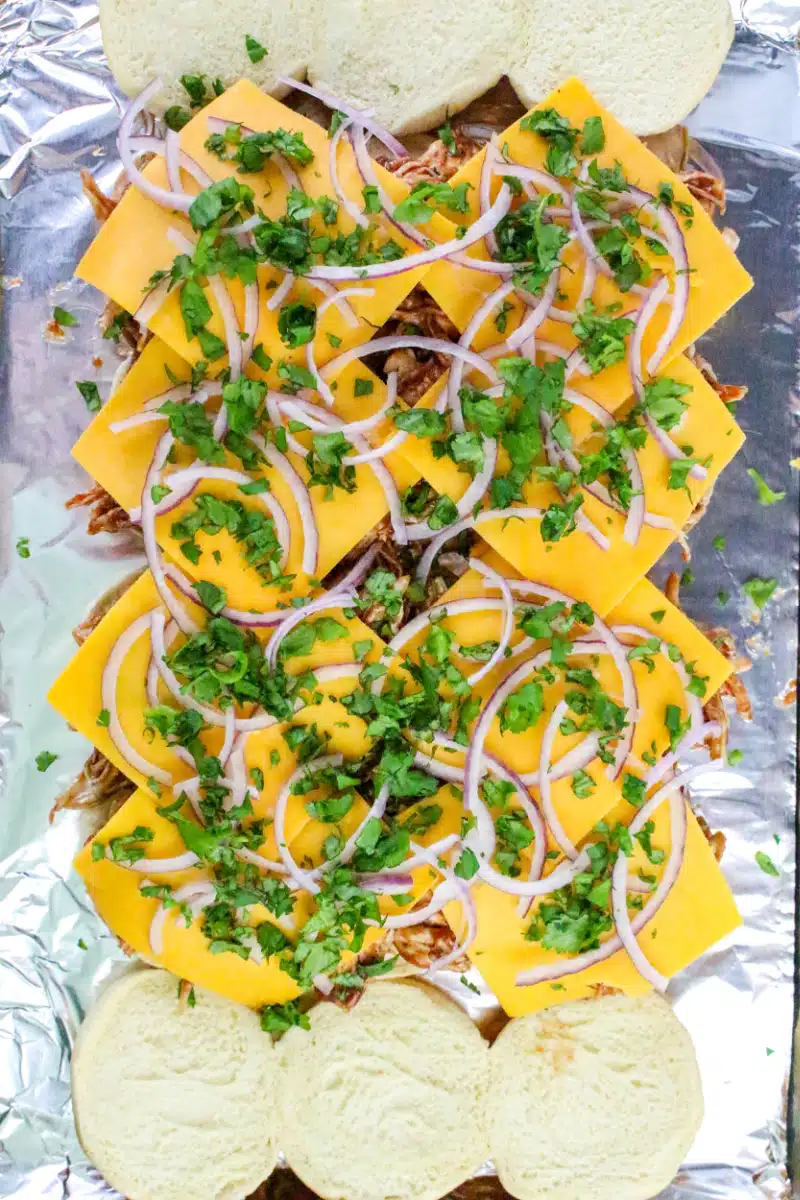 topping slider filling with cheese, red onion and cilantro