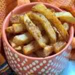 bowl of seasoned french fries with text overlay
