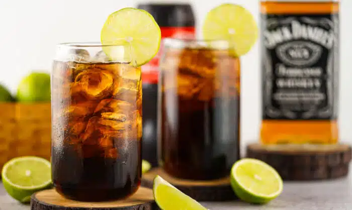 two glasses of jack daniels ans coke with lime