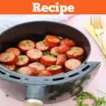sliced kielbasa in an air fryer basket with text overlay