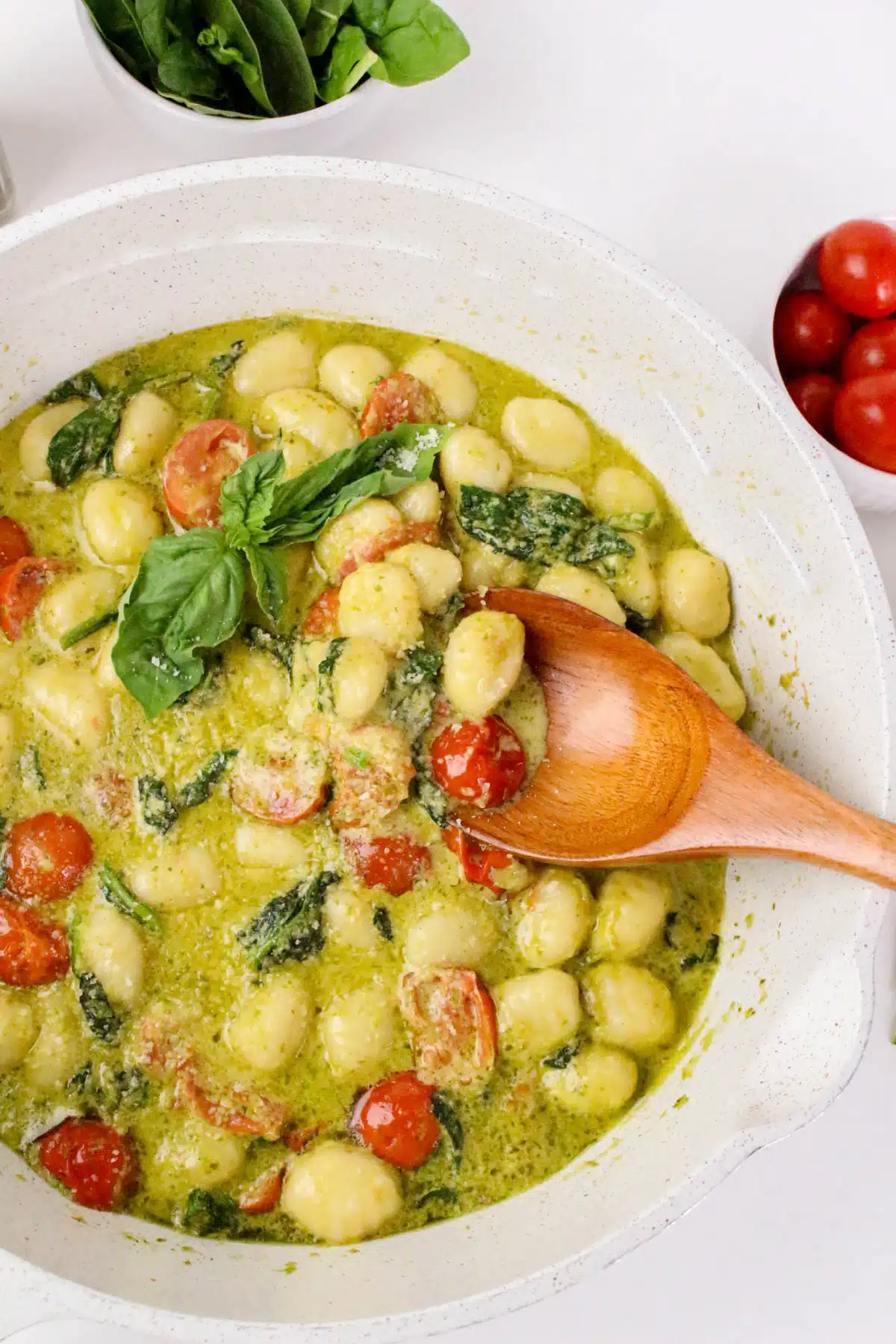 gnocchi with pesto sauce on a wooden spoon
