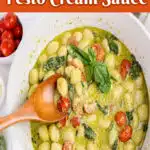 white bowl with gnocchi pasta in a cream sauce with wooden spoon and text overlay