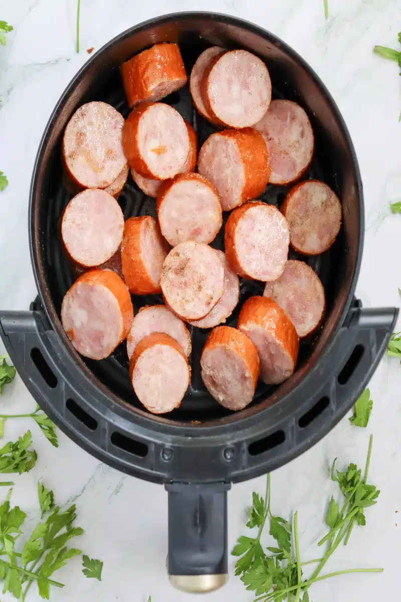 sliced kielbasa in the air fryer basket