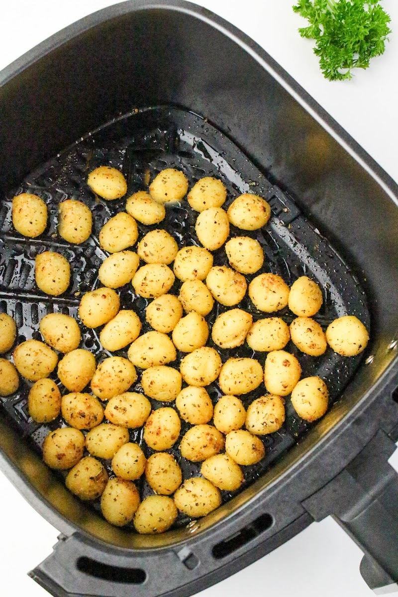 crispy gnocchi in the air fryer basket after cooking