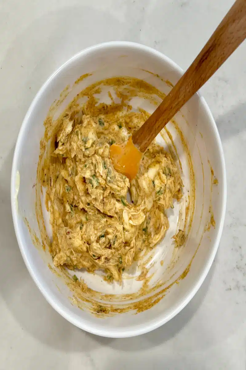stirring cowboy butter ingredients in a mixing bowl