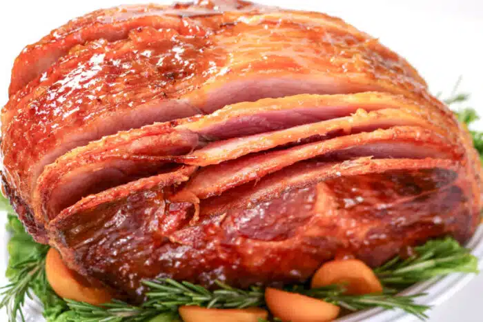 sliced spiral ham on a bed of greens