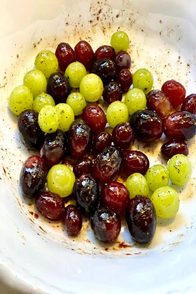 tossing grapes with balsamic mixture