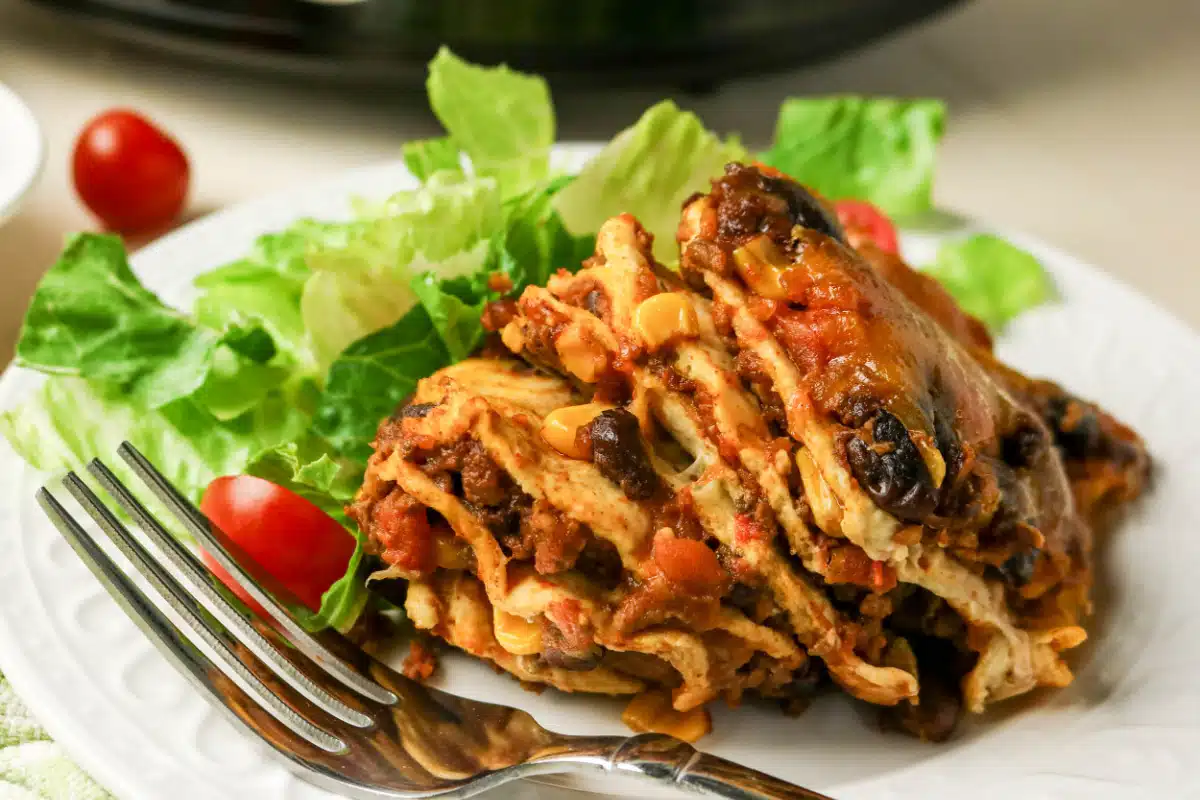 layered taco casserole serving on a plate