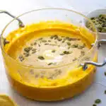 creamy pumpkin soup with pumpkin seeds garnish