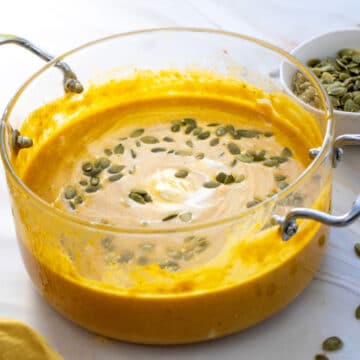 creamy pumpkin soup with pumpkin seeds garnish