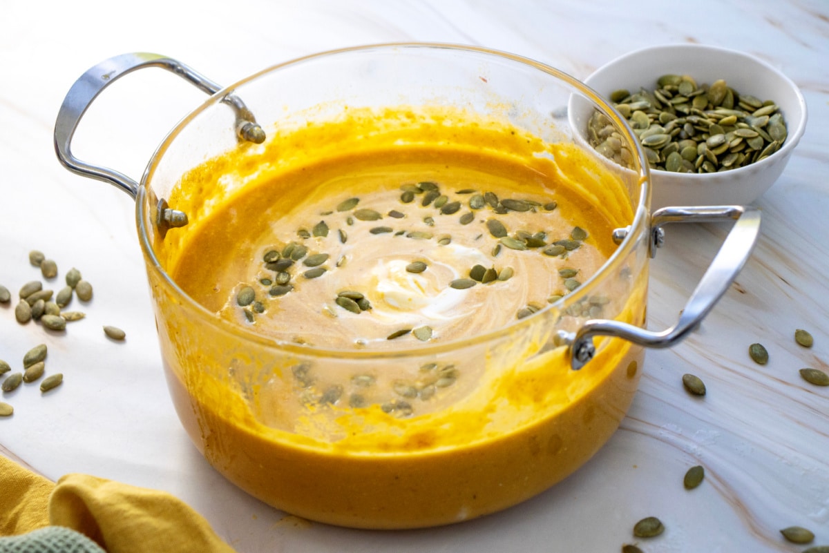 creamy pumpkin soup with pumpkin seeds garnish