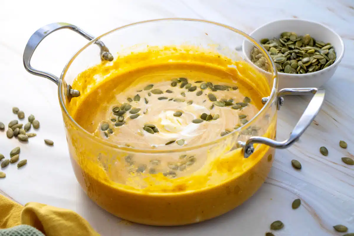 creamy pumpkin soup with pumpkin seeds garnish
