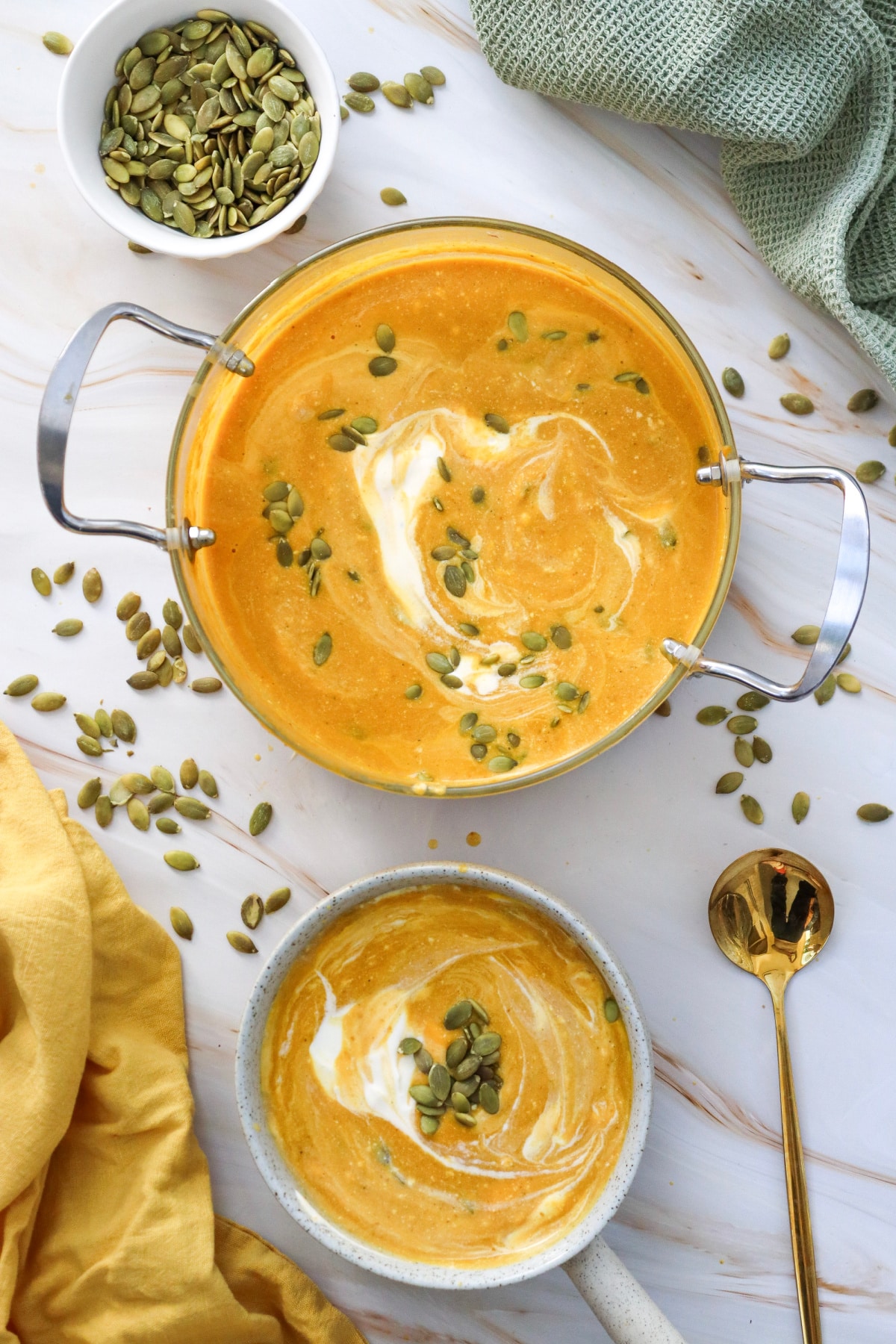 overhead of pumpkin soup in a pot and in a bowl