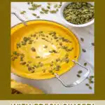 creamy pumpkin soup with pumpkin seed garnish and text overlay