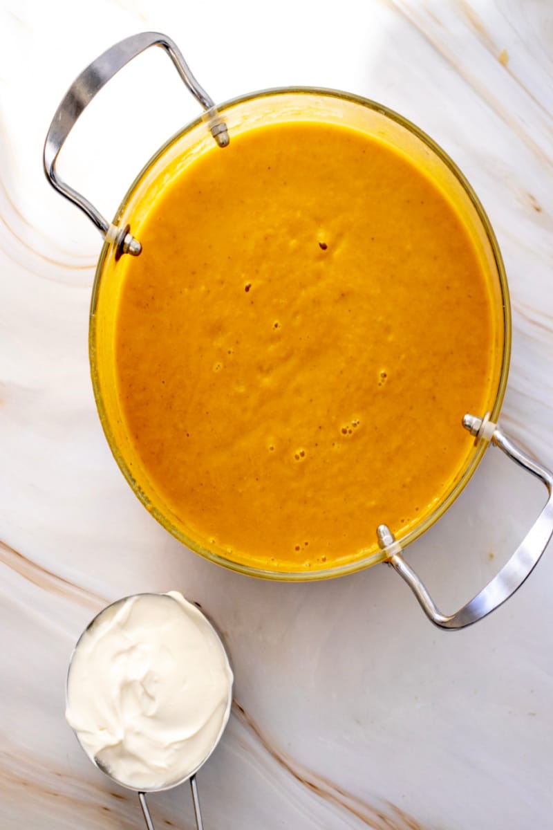 Transfer soup to serving bowls and swirl with creme fraiche, if desired.