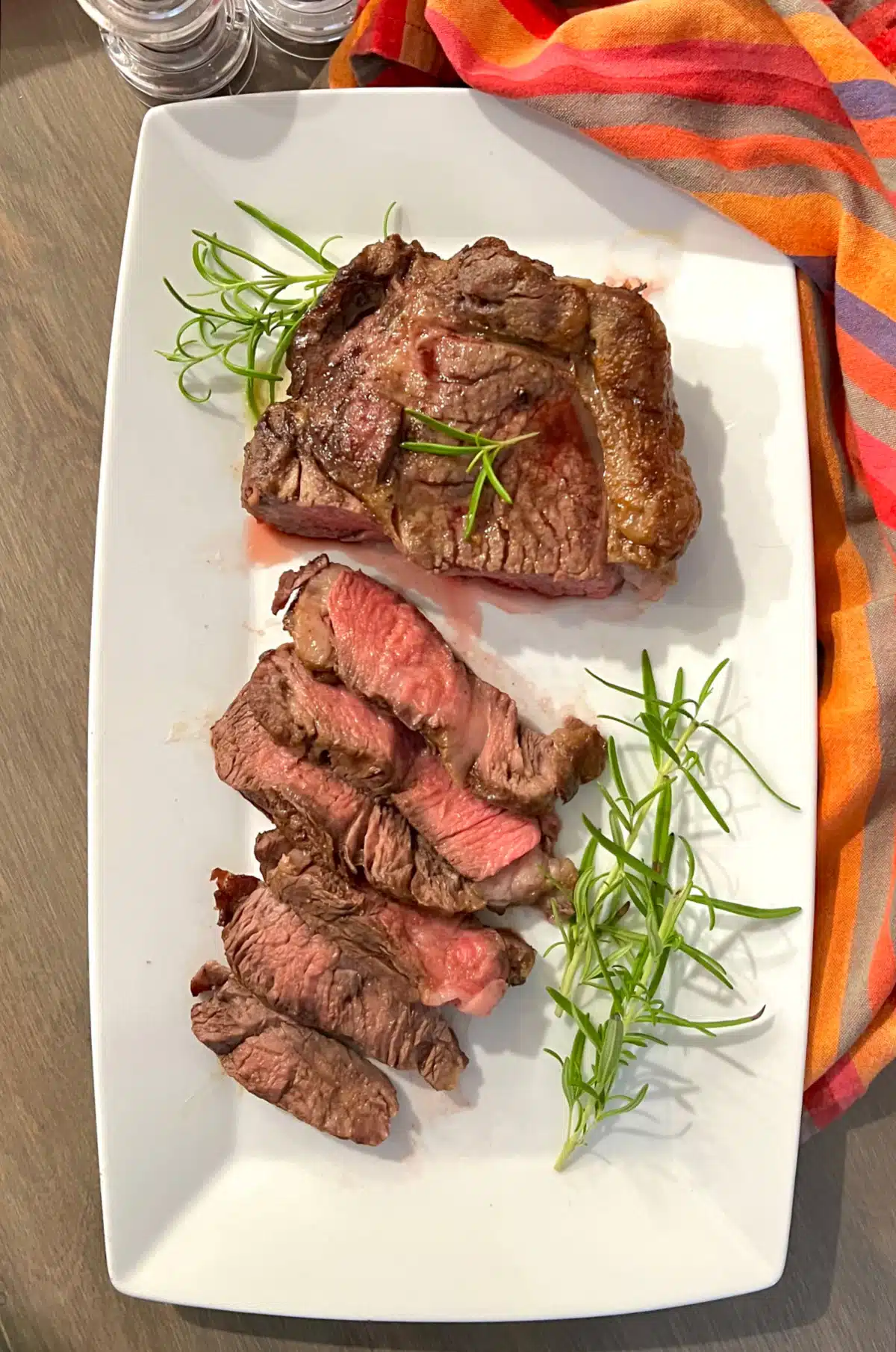 overhead of sliced ribeye steak on a platter