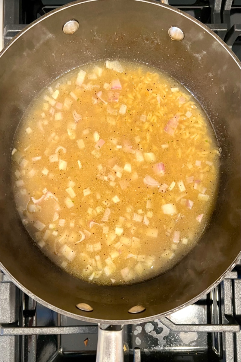 cooking shallots, seasonings and broth in a skillet