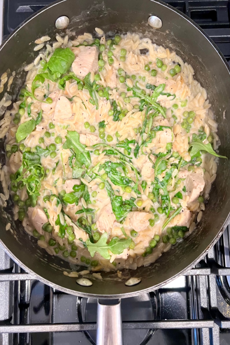 cooking until arugula is wilted and a sauce forms